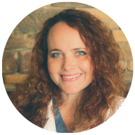 Profile Picture of Kara Amstutz, DVM and CEO with long curly hair and blue eyes smiling