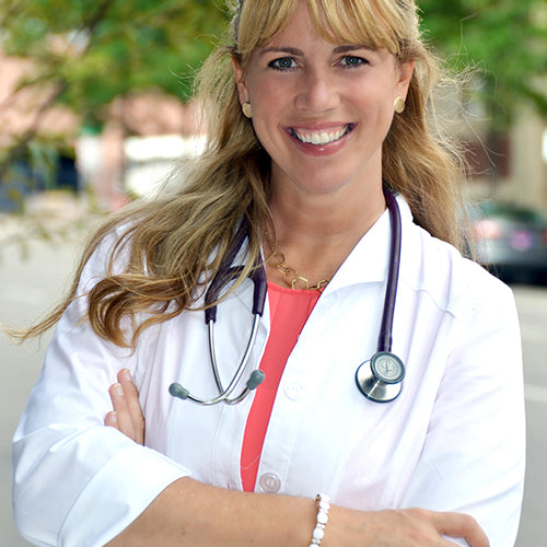 Photo of veterenarian woman wearing a stethoscope and white lab coat with short sleeves.